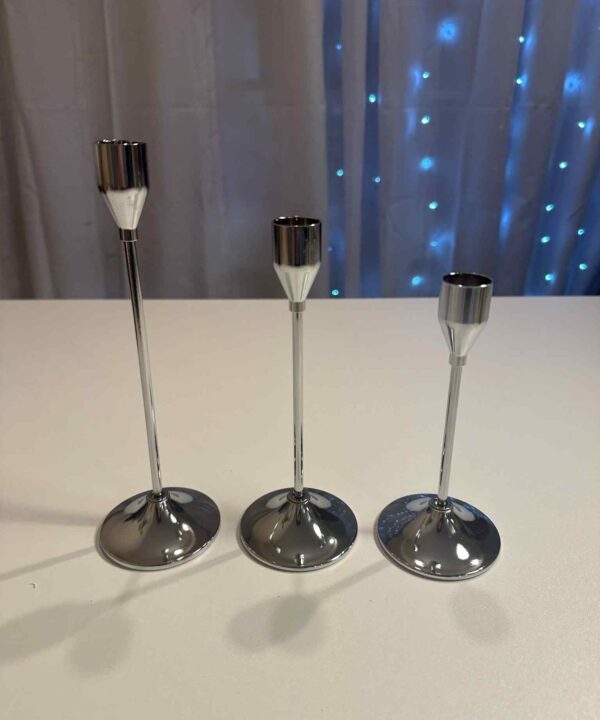Trijų dydžių žvakidės, sidabro spalvos.